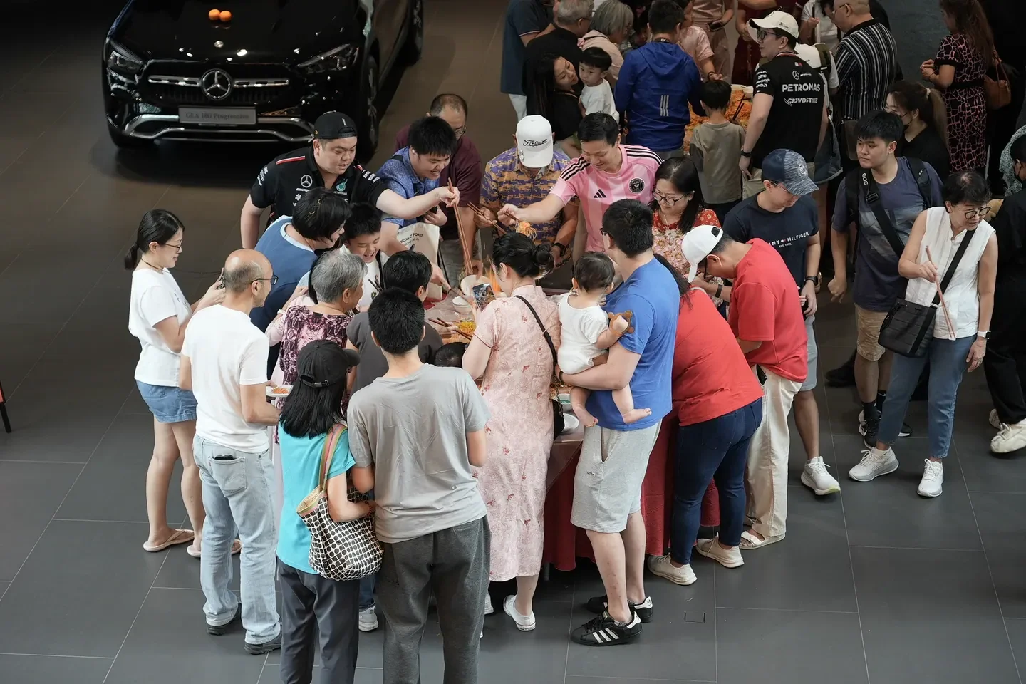 Guests taking part in a staffed activity inside a Mercedes-Benz showroom