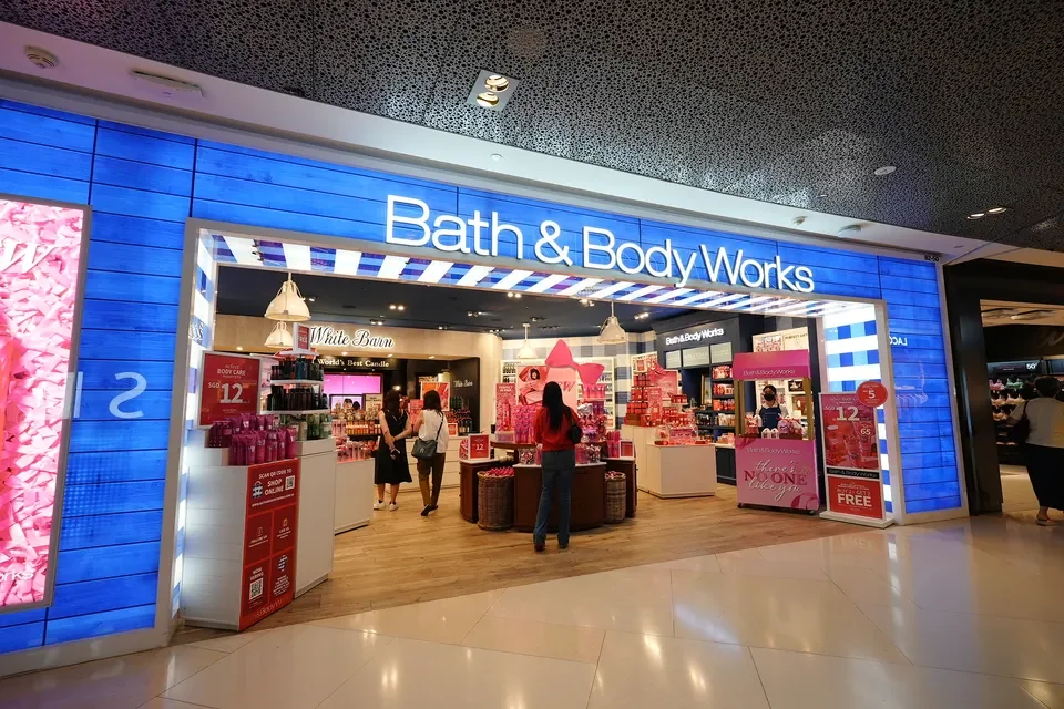 Bath & Body Works storefront and branded pink activation stations in a Singapore shopping mall
