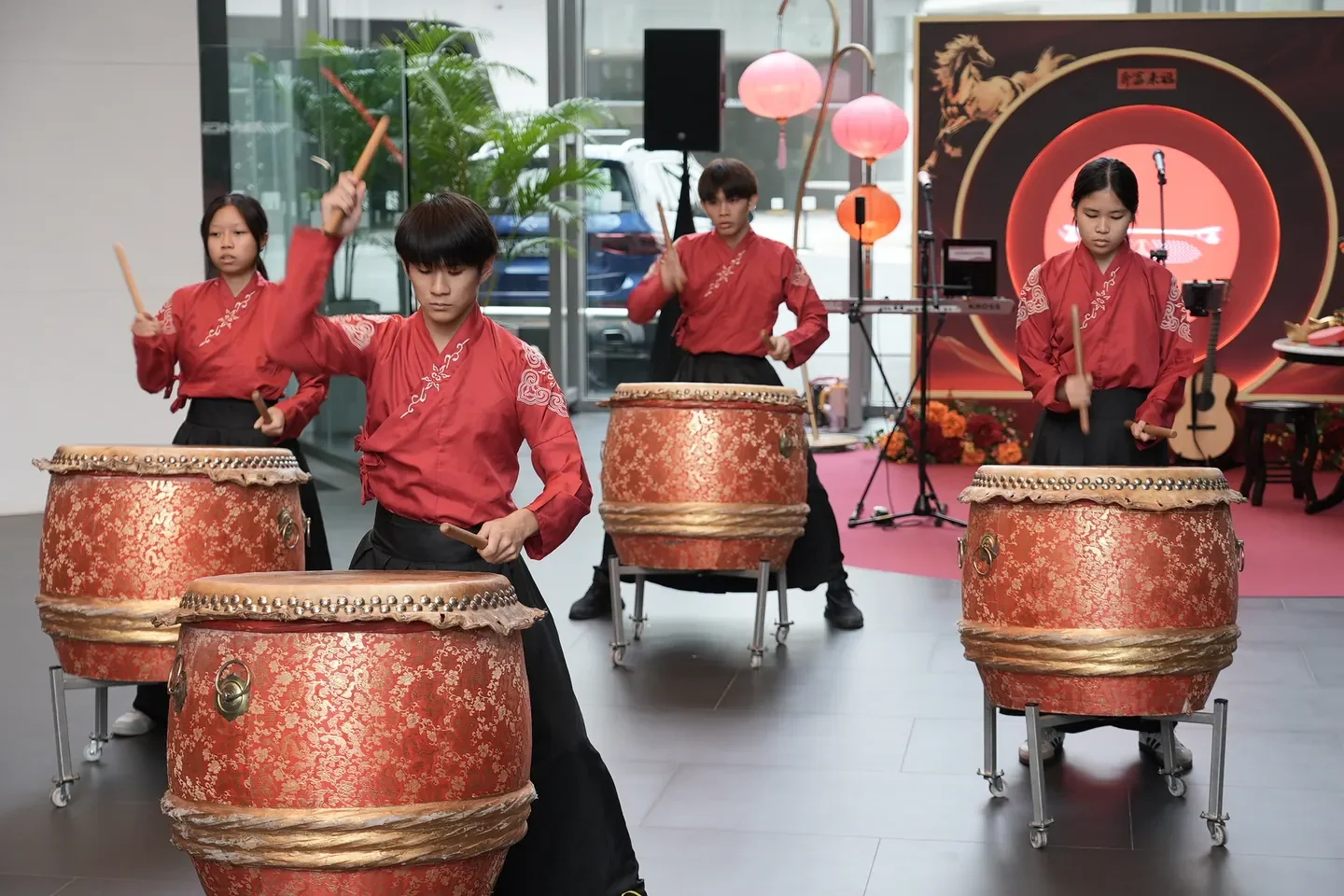 A coordinated live drum performance at a Mercedes-Benz showroom event