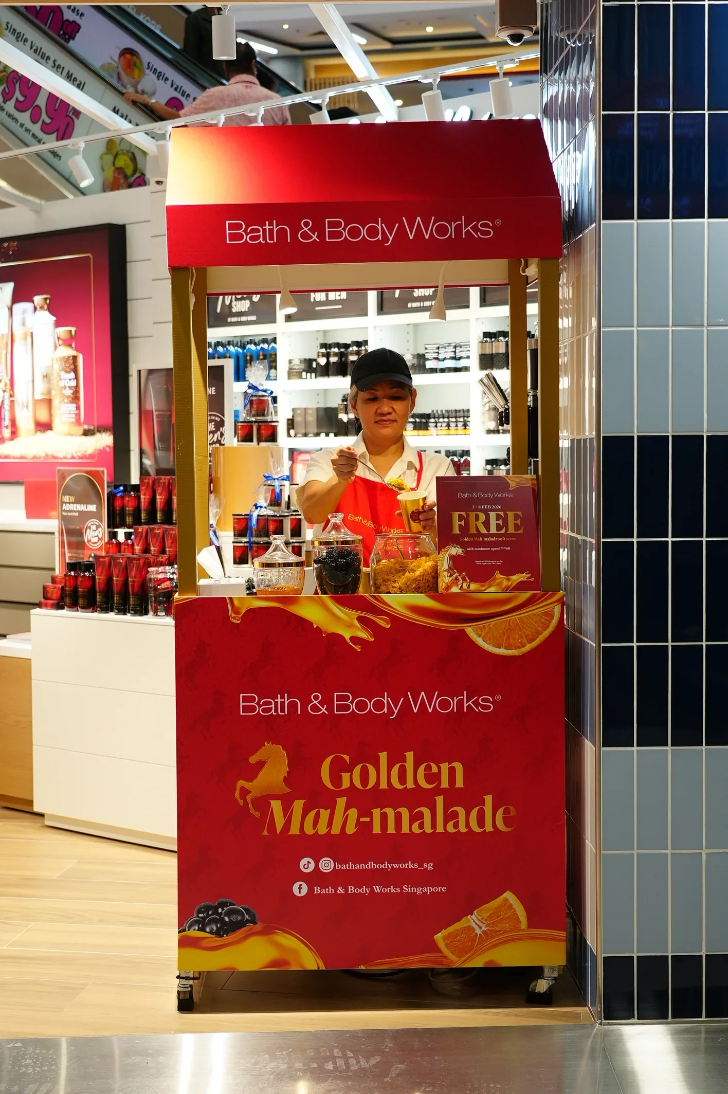 Red Bath & Body Works Golden Mah-malade dessert cart beside the store entrance