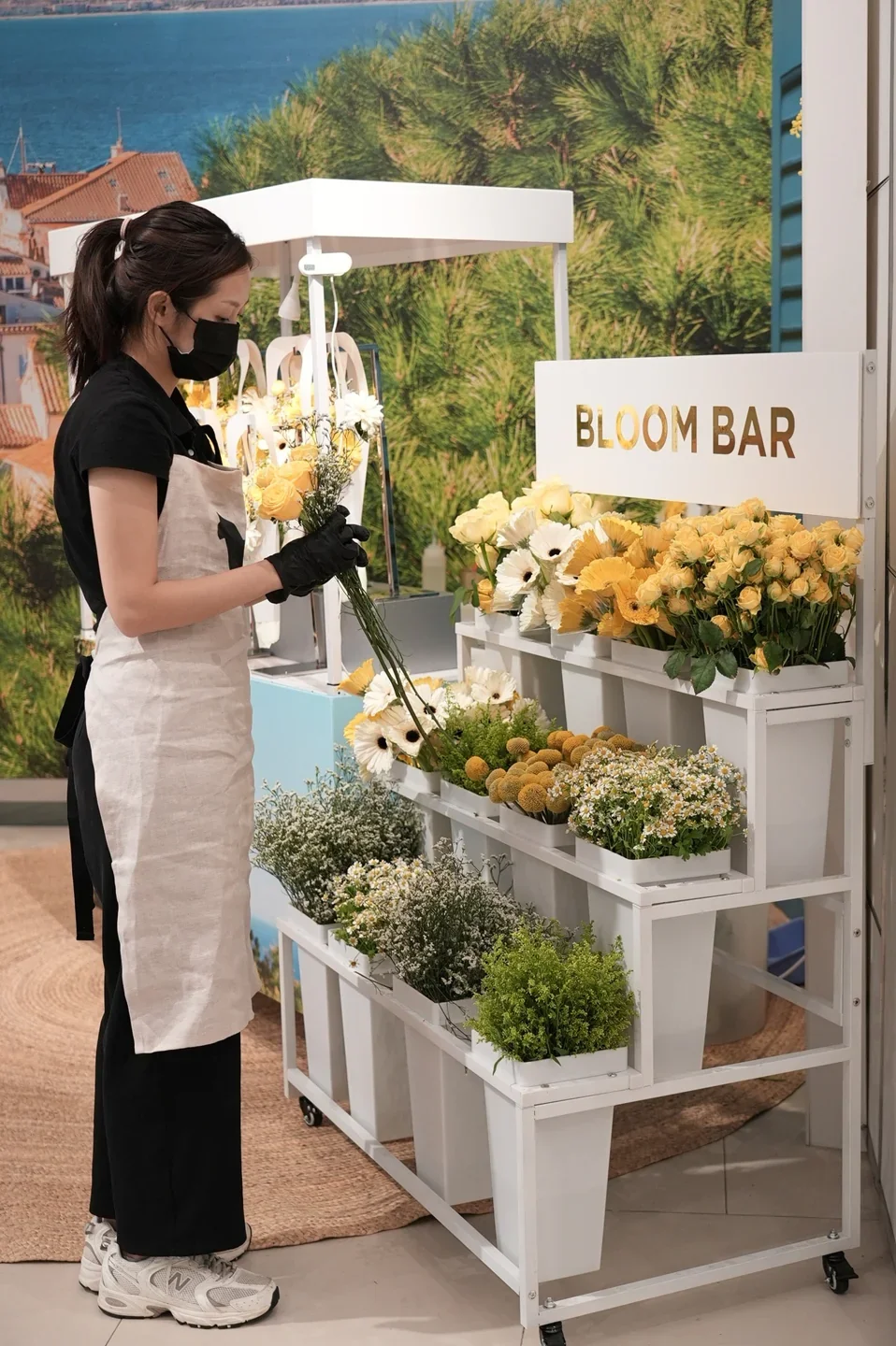 A florist arranging flowers at the Michael Kors Bloom Bar.